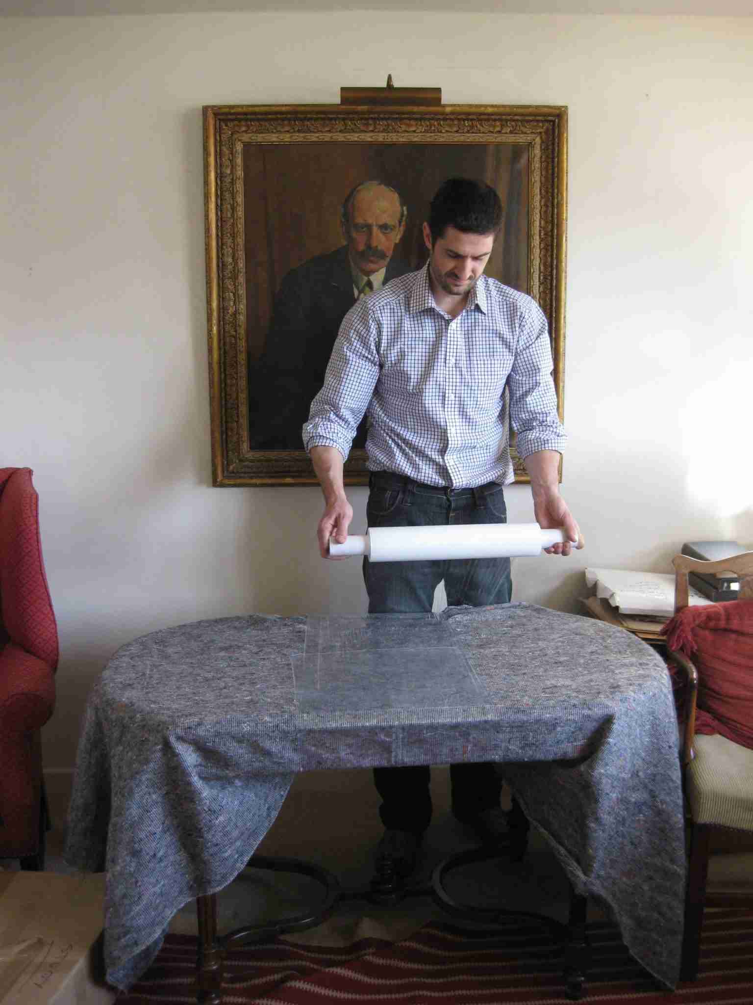 MiniMoves packing team using blankets and plastic wrap to protect an antique table